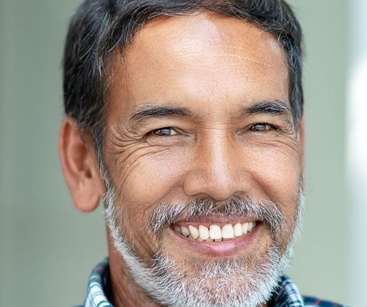 Middle aged implant patient smiling